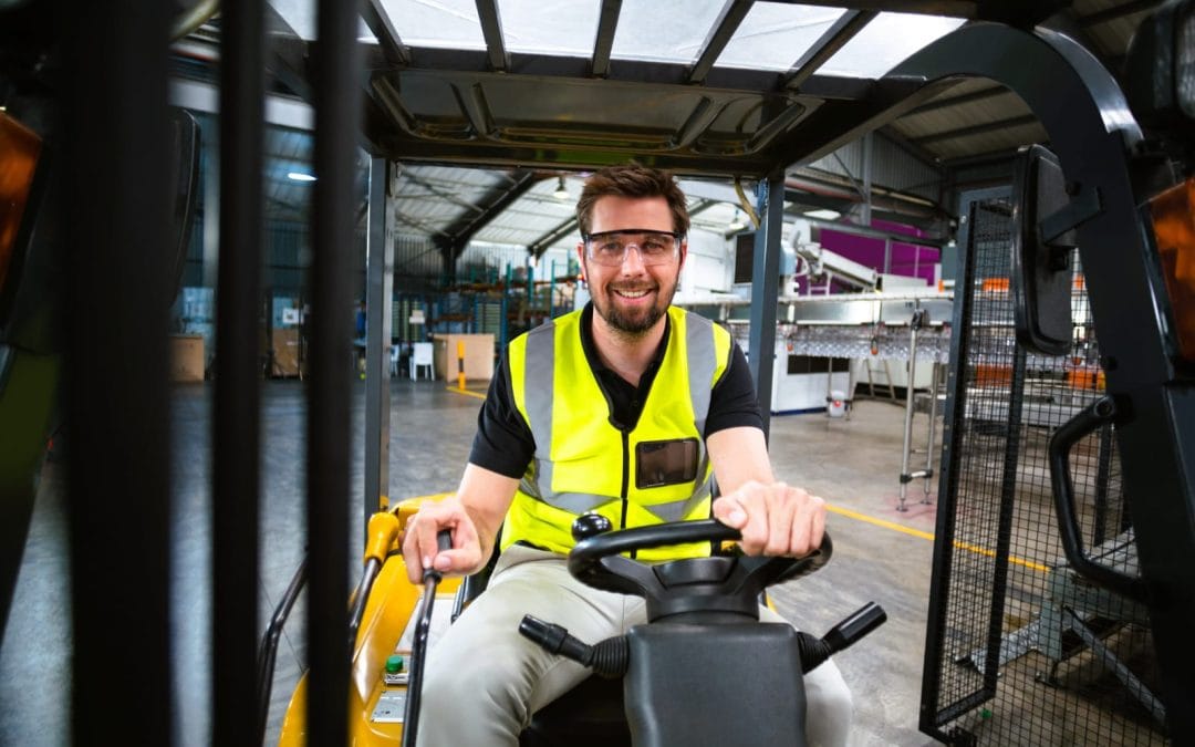 man-operating-forklift-in-a-warehouse-setting