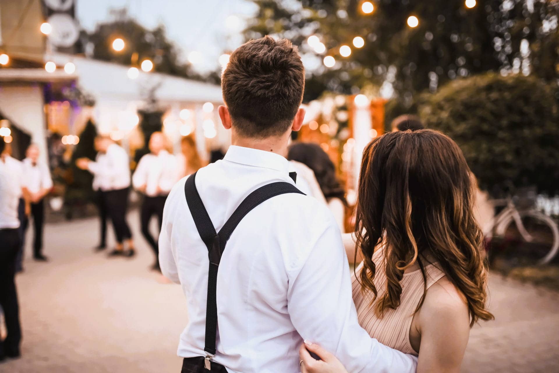 10 Ways to Calculate How Many Porta Potties You Need for an Event young couple-holding-each-other-at-outdoor-celebration